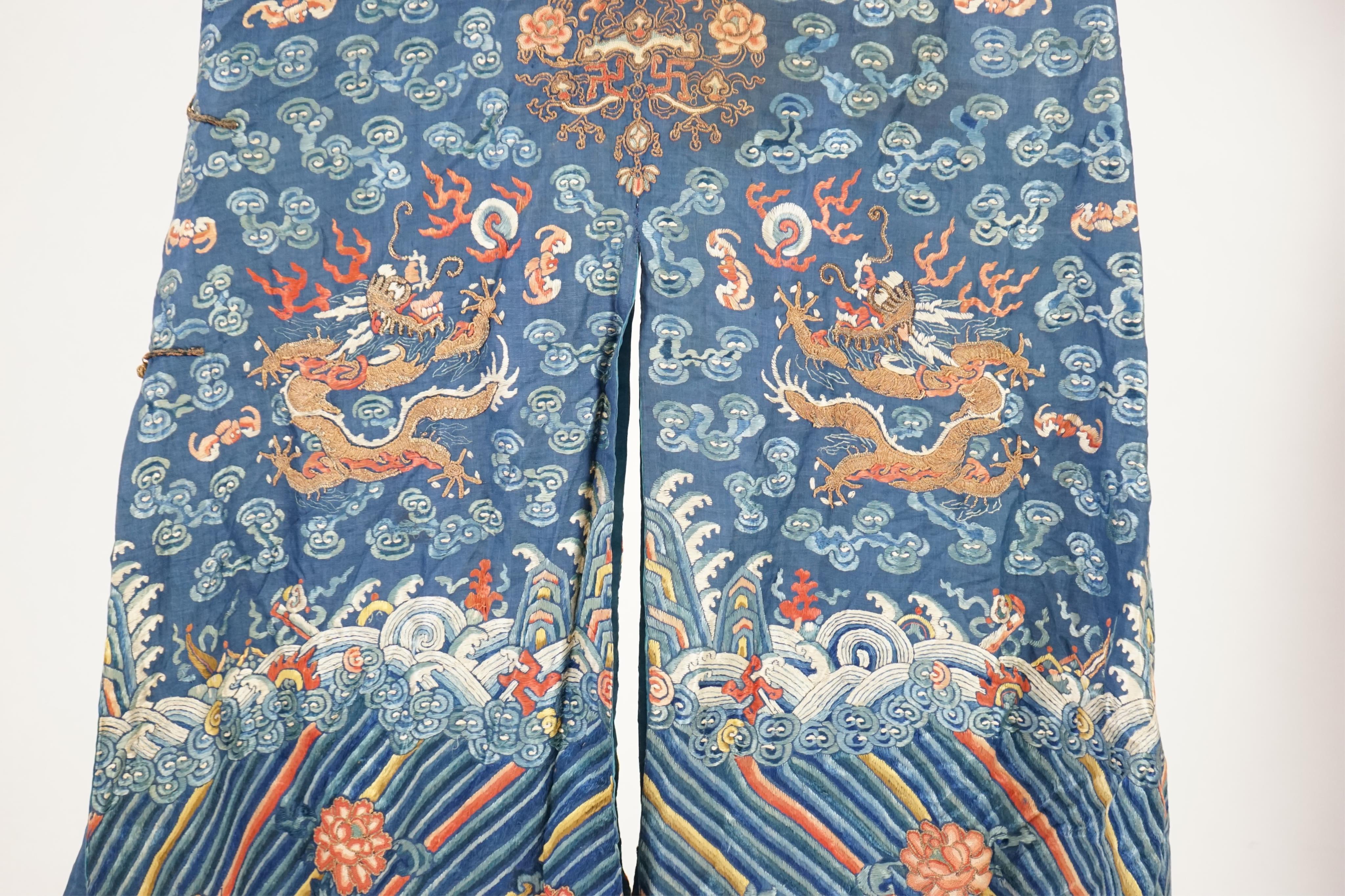 A Chinese blue silk ‘dragon’ robe, jifu, late 19th century and a mandarin hat